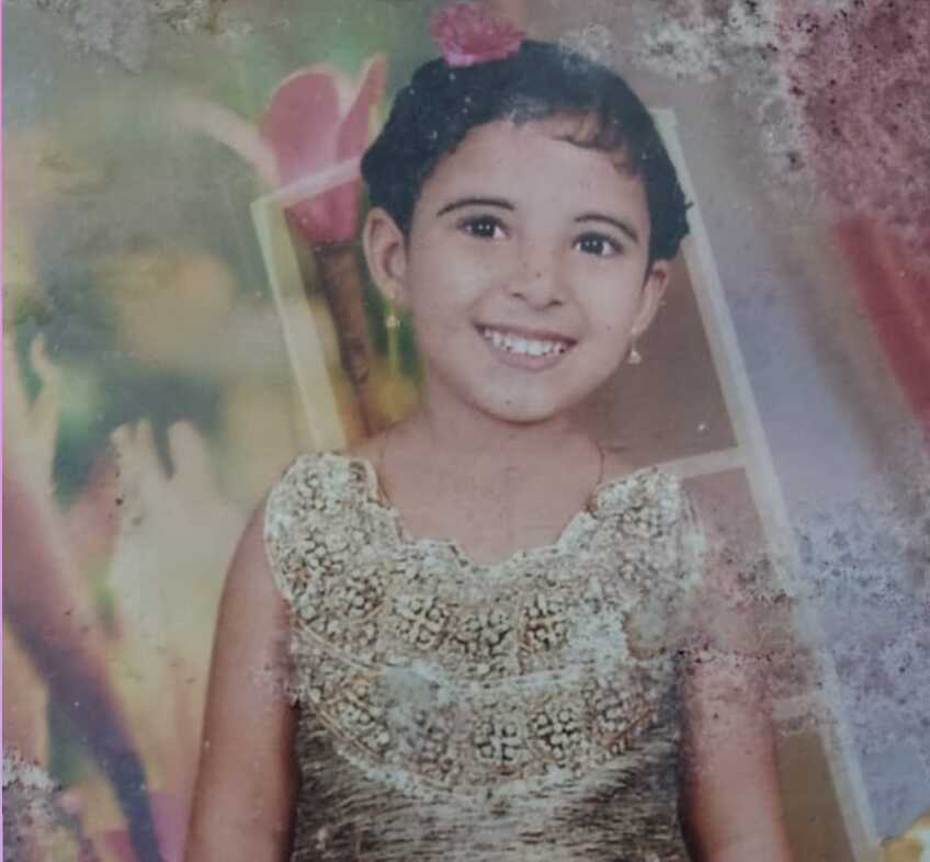 Open book with golden light and floating words